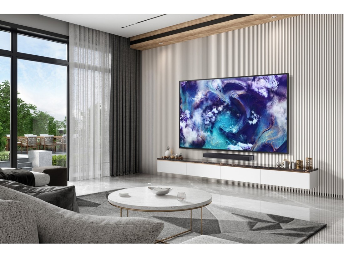 Samsung QN900F wall mounted above a soundbar in a living room