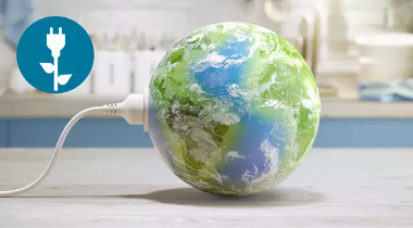 Globe plugged into a socket with a small plant, representing energy saving
