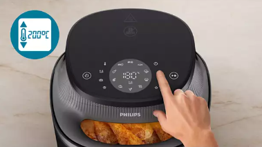 Hand touching the touchscreen control panel of the Philips Airfryer